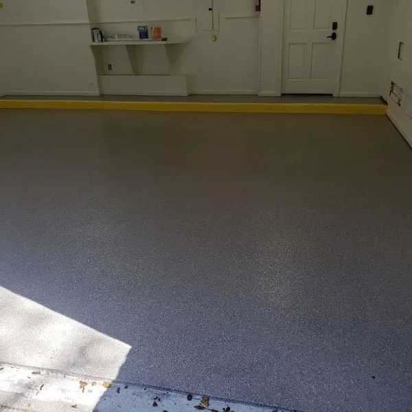 Well-maintained glossy epoxy garage floor in a Lee County home