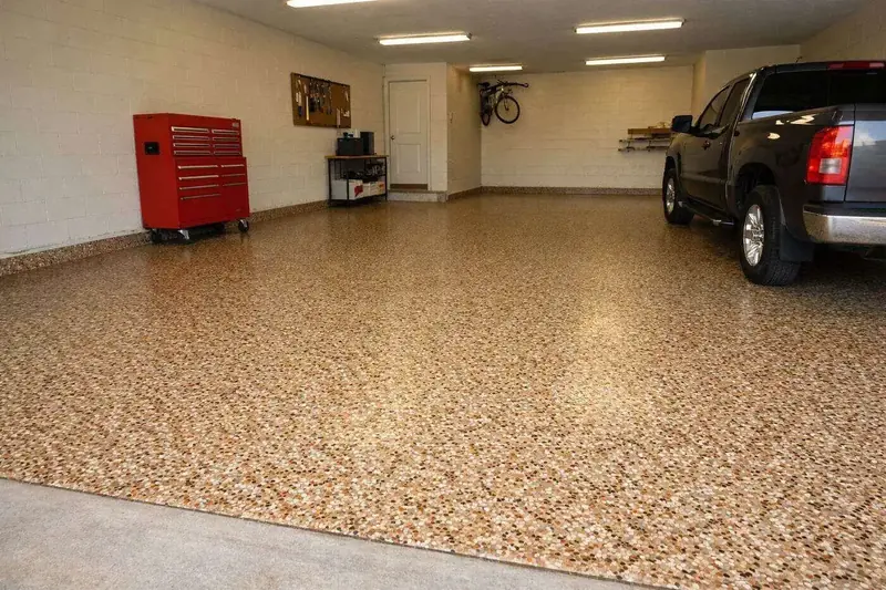 Flake epoxy garage floor with a polyaspartic topcoat in a Lee County home